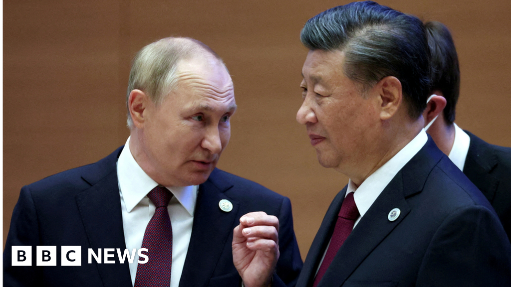 Russian President Vladimir Putin speaks with Chinese President Xi Jinping