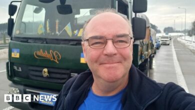 Steve Hodgson takes a picture in front of his truck