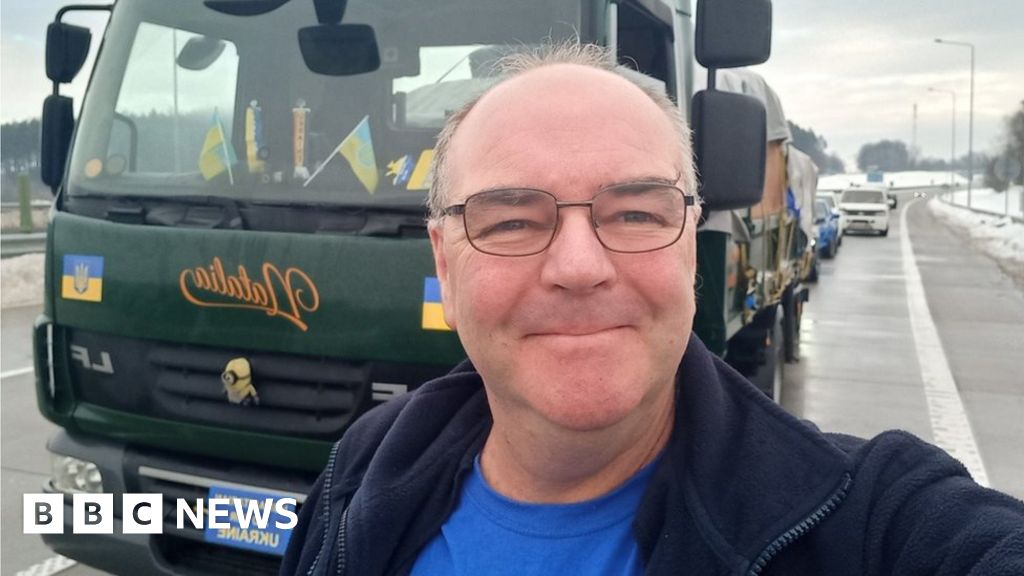 Steve Hodgson takes a picture in front of his truck