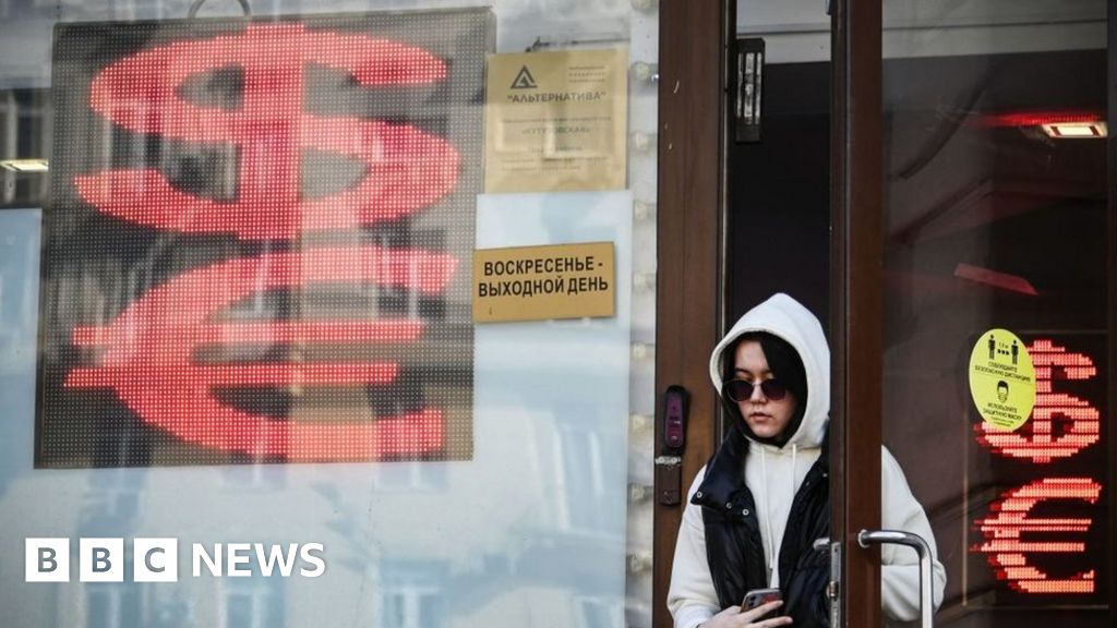 A woman leaves a currency exchange office in central Moscow