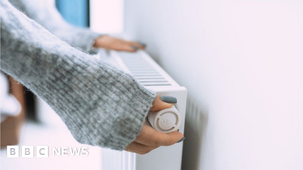 Woman changes temperature on radiator