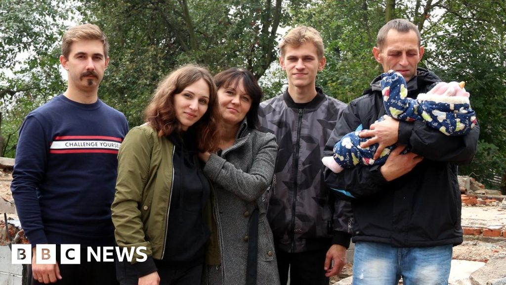 Pylypenko family in front of their destroyed house