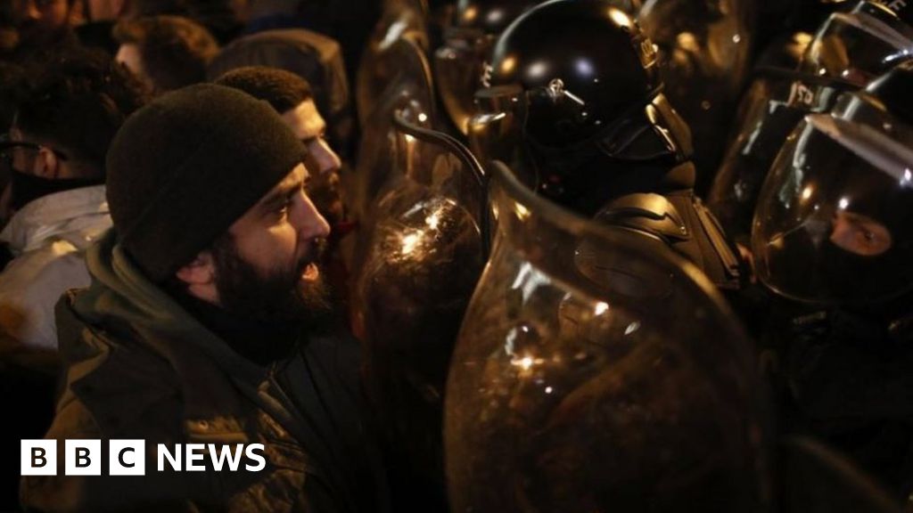 Protesters face off against riot police