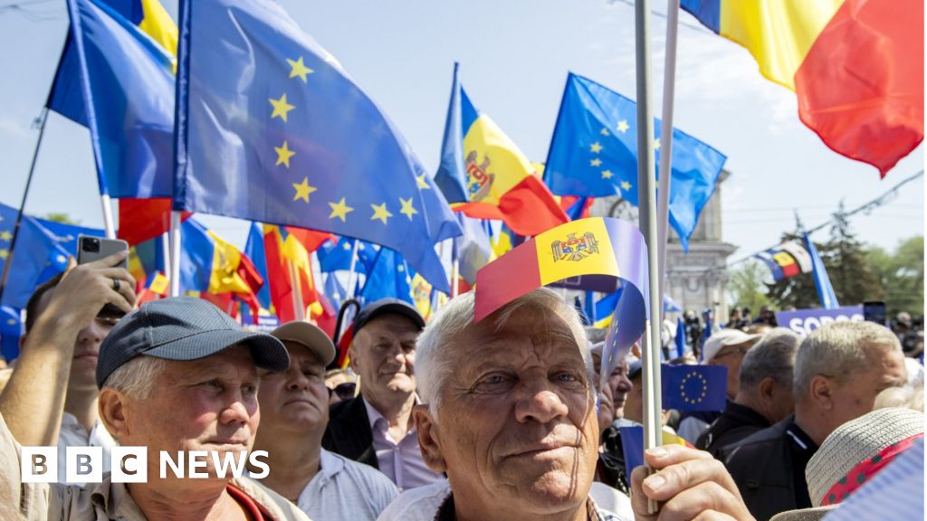 Moldovans wave EU flags during a pro-European rally in Chisinau on Sunday