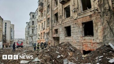 Ukrainian rescuers work at the site of a damaged residential building following a missile strike, in Kharkiv, north-eastern Ukraine, 05 February 2023