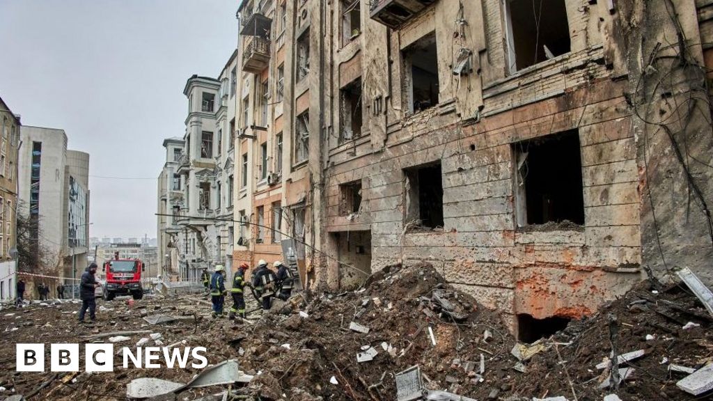 Ukrainian rescuers work at the site of a damaged residential building following a missile strike, in Kharkiv, north-eastern Ukraine, 05 February 2023