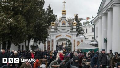 People pray outside a church in the compound of the Kyiv Pechersk Lavra monastery on 29 March