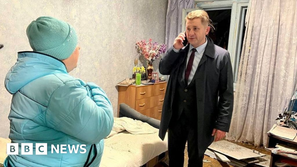 Belgorod Mayor Valentin Demidov speaks with a local resident affected by the blast
