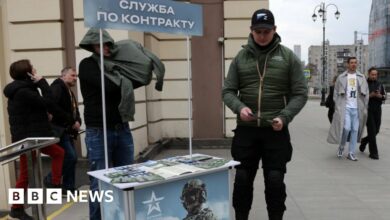 A man holds promotional materials of the Russian Defence Ministry, campaigning to sign up for contract service on April 9, 2023 in Moscow, Russia
