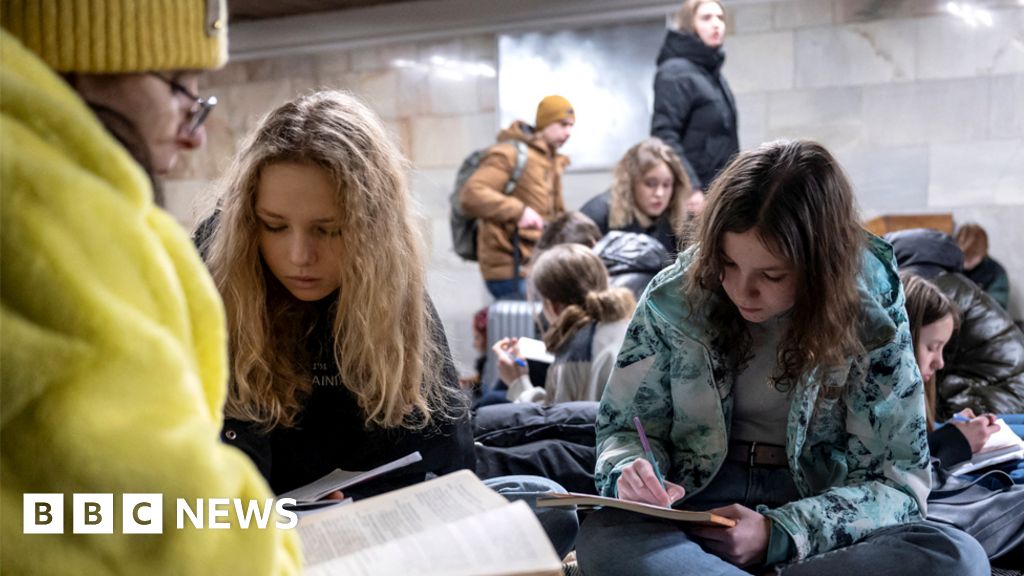 A crowd of people take shelter in a Kyiv metro station