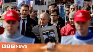 President Putin carrying a photograph of his father during last year's Victory Day celebrations
