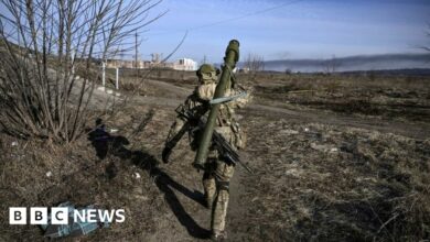 A Ukrainian serviceman walks towards the front line in Irpin last year