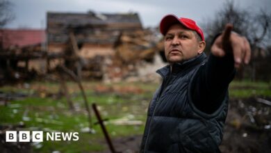 A civilian north of Kyiv points to where Russian forces destroyed his home